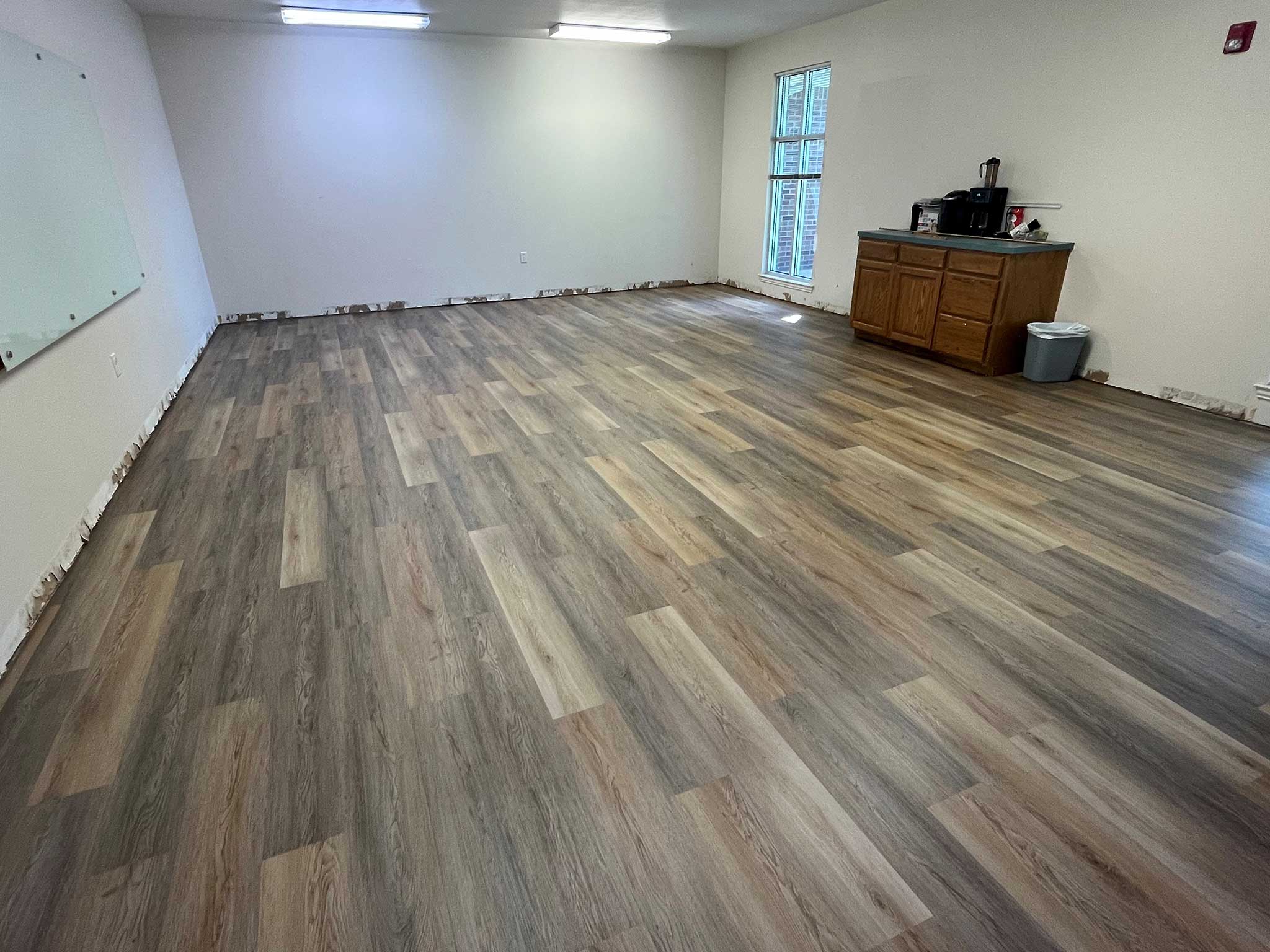 Office interior with installed glue-down LVP flooring